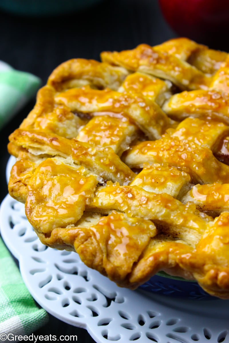 Mini apple pie with lattice crust on top that has baked super flaky.