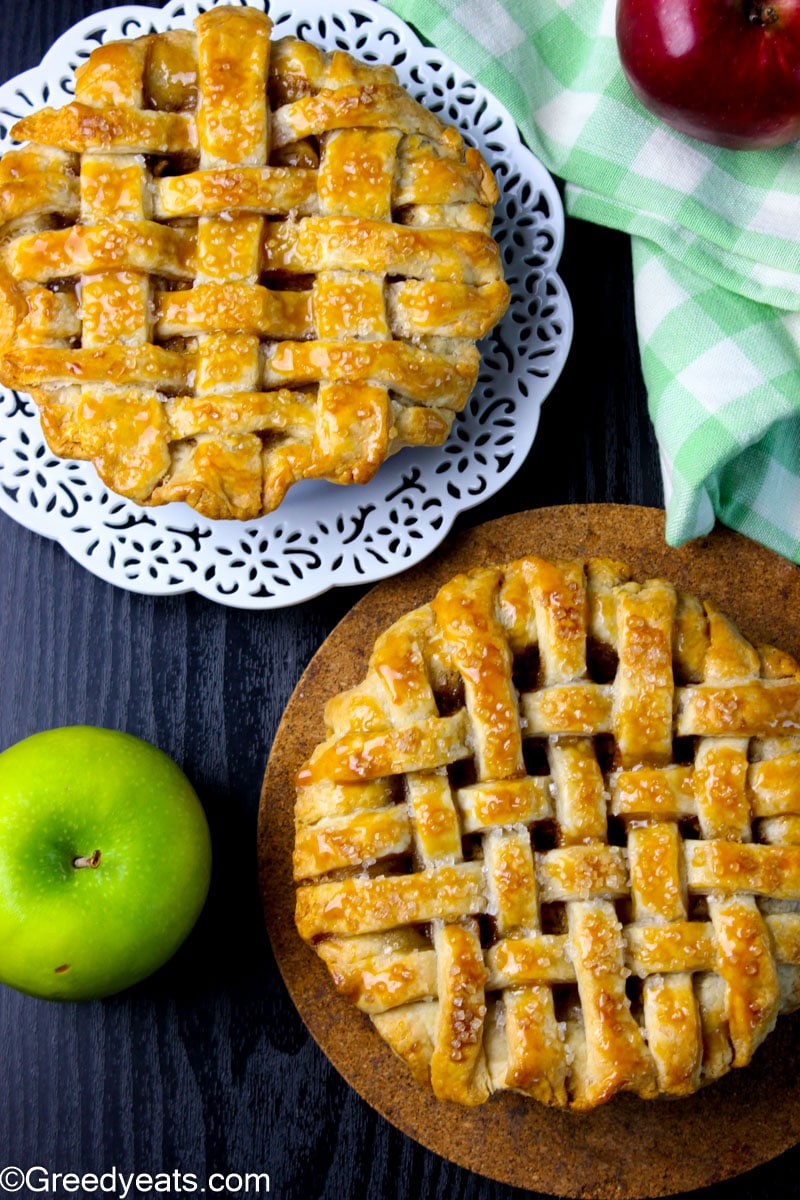 Two mini Apple Pies baked in 5 inches pie dishes, sprinkles with coarse sugar.