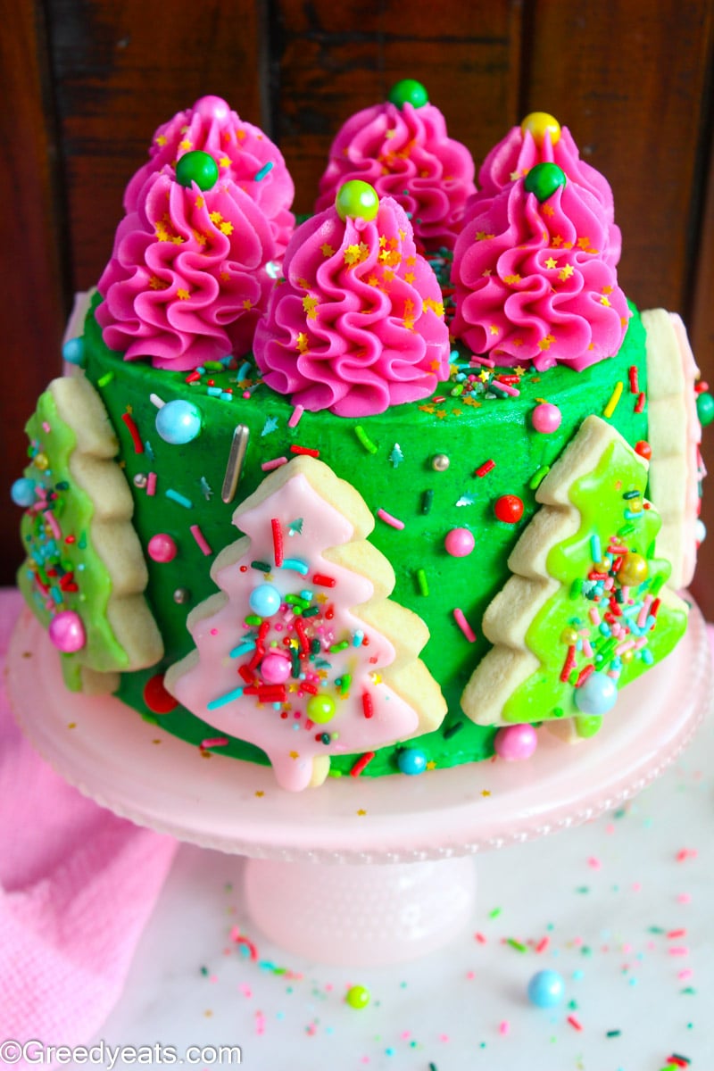 Orange cake decorated with Christmas Themed Buttercream and iced sugar cookies.