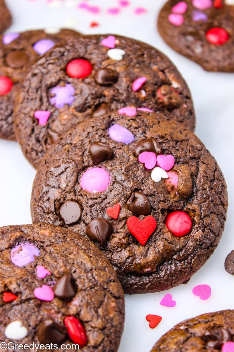 Chocolate m&m cookies topped with valentines m&ms and chocolate chips.