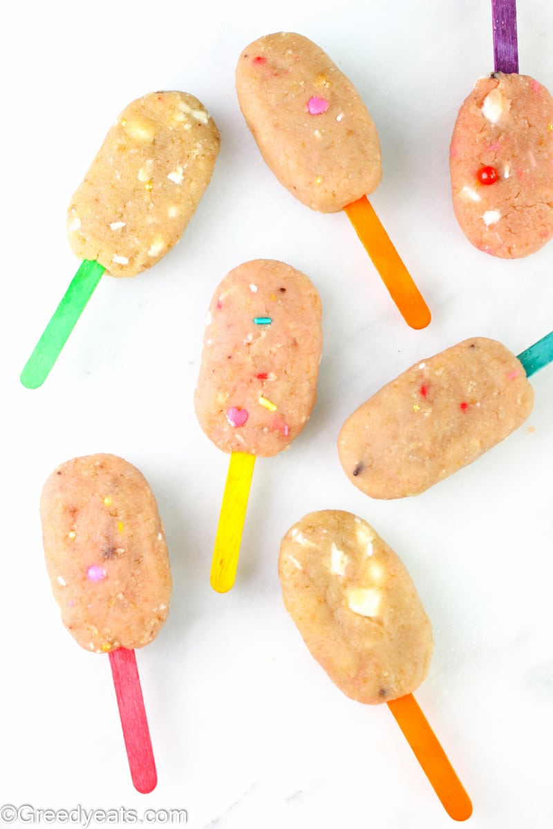 Cake pops on a stick ready to be dipped in melted chocolate.