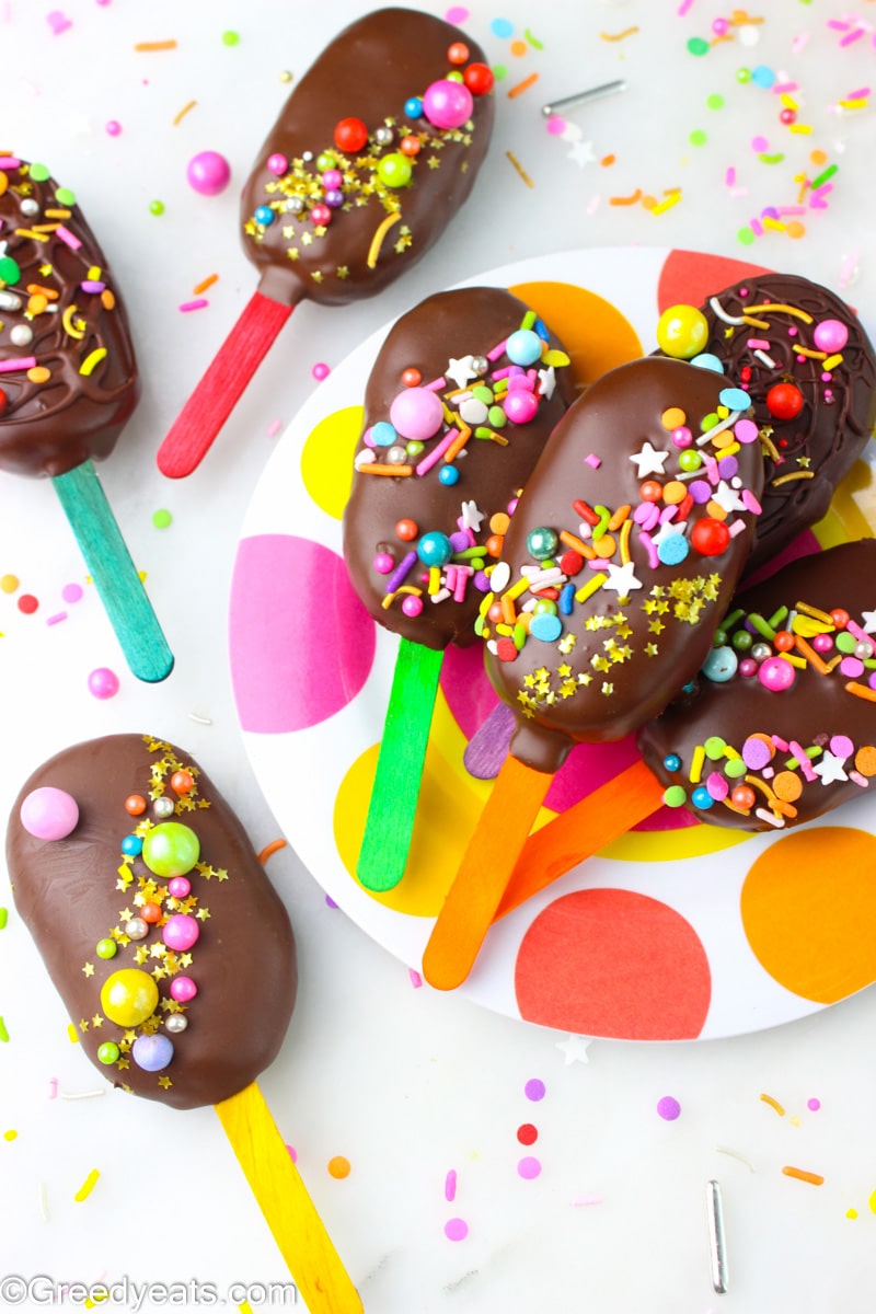 Vanilla Flavored Cakesicles with birthday sprinkles served on a birthday themed plate. 