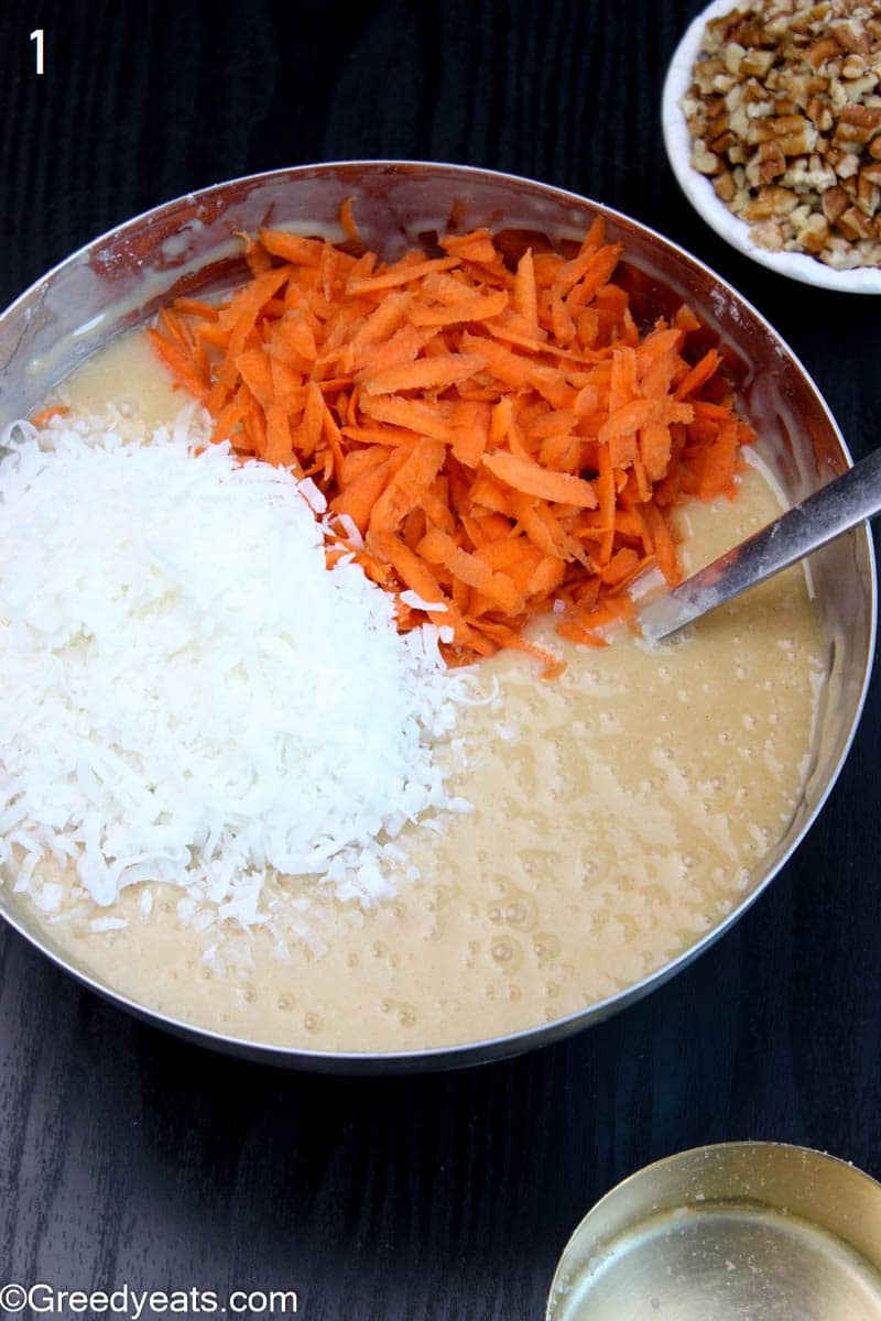 Folding carrots and coconut in cake batter.