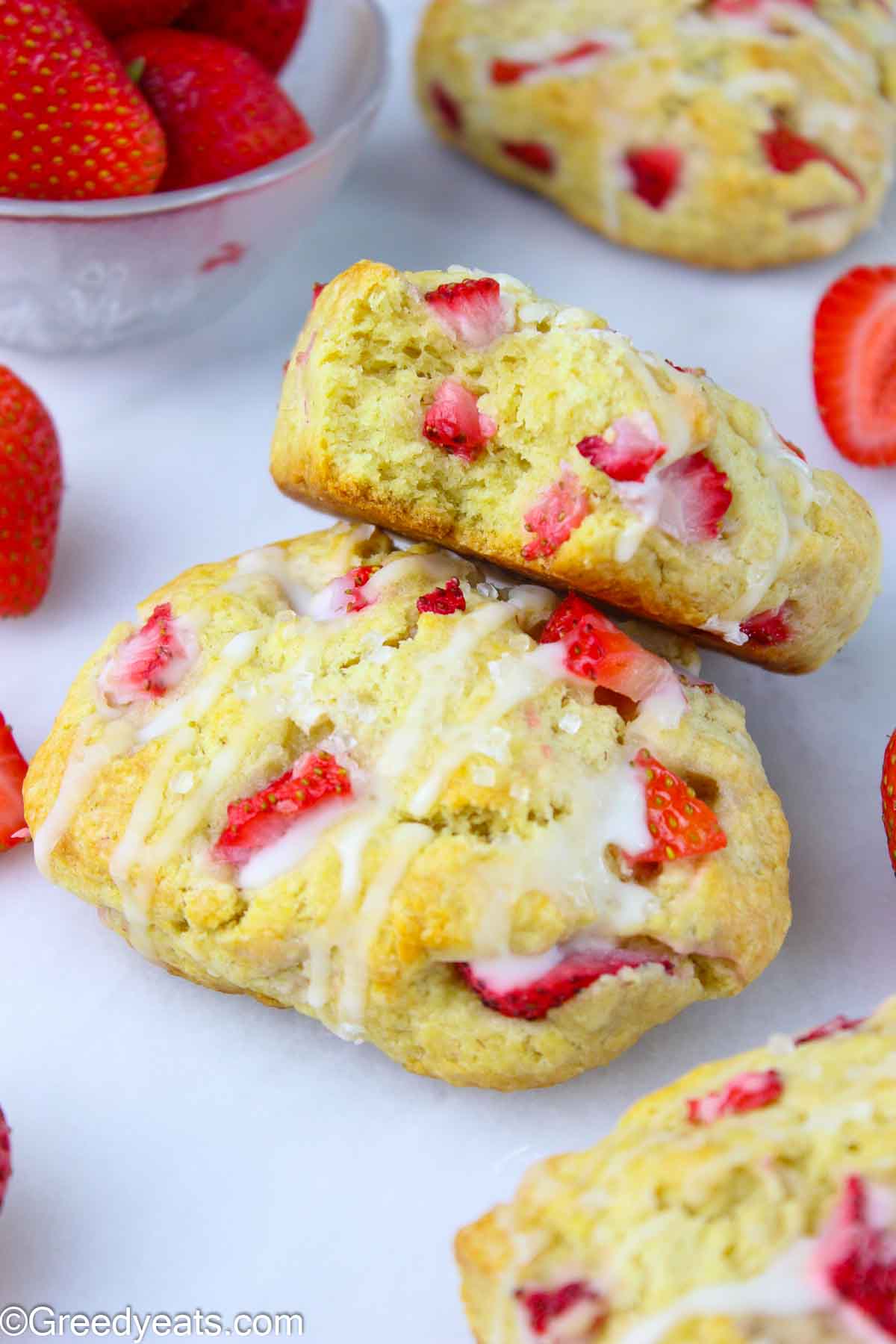 Easy Strawberry Scones recipe topped with sparkling sugar and vanilla glaze.