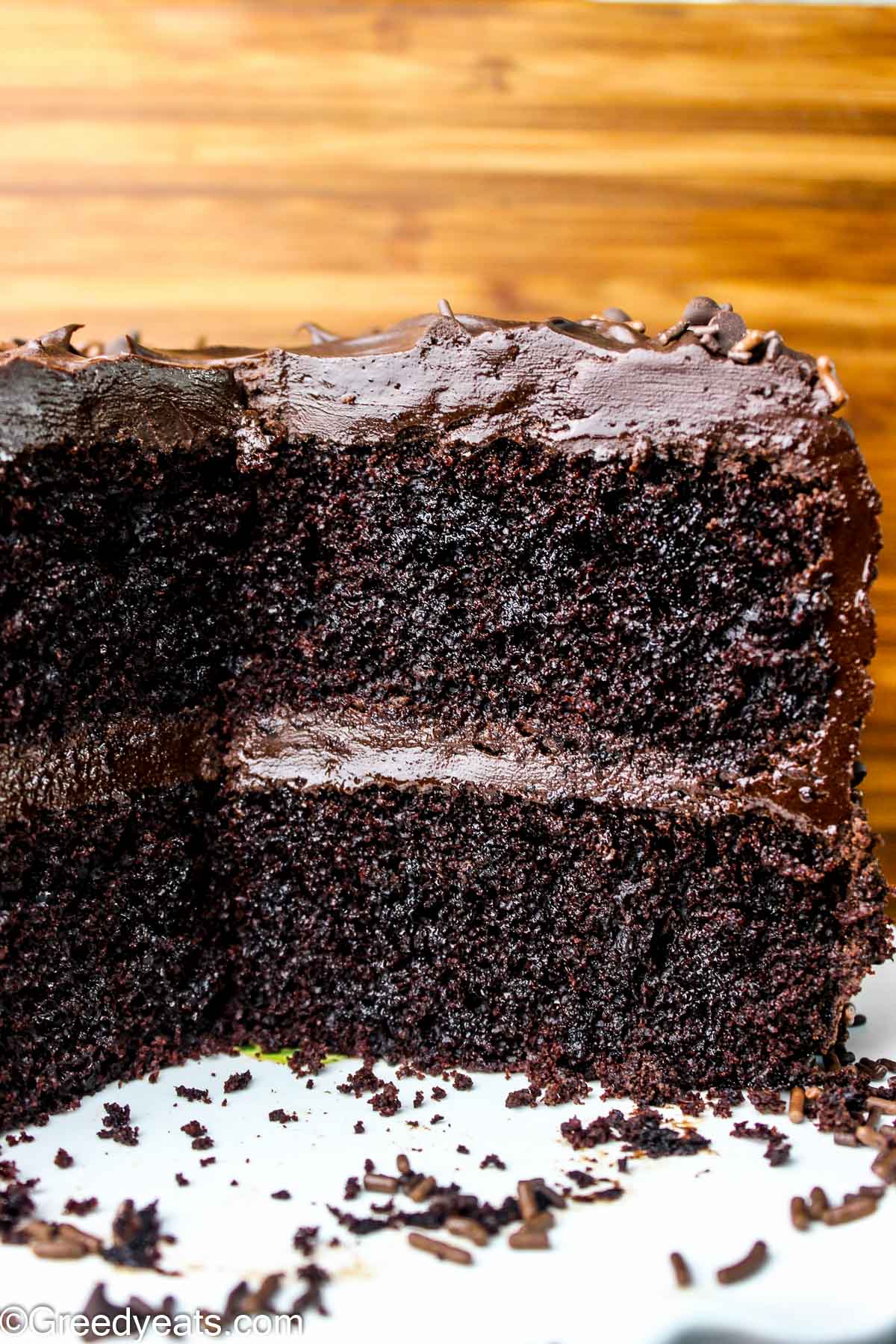 Double layer Chocolate Cake topped with easy chocolate fudge frosting kept on a cake stand.