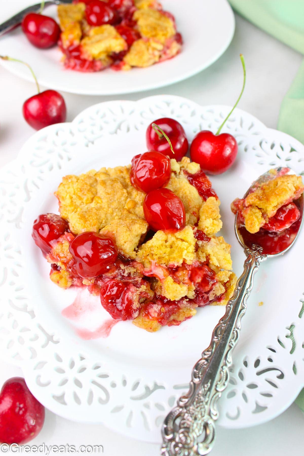 Warm, soft and crumbly cherry dump cake slice with gooey cherry pie filling.