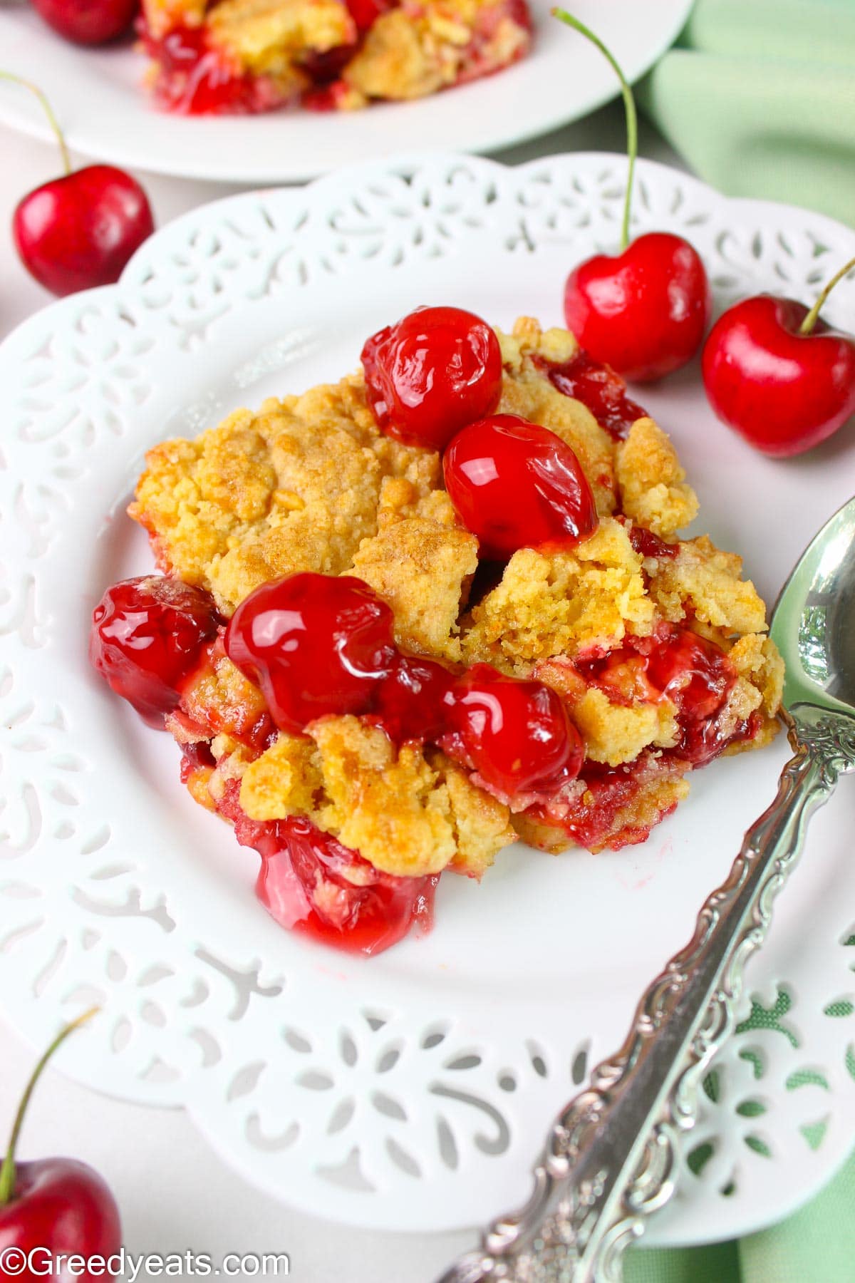 Easy Cherry Dump Cake Recipe with cherry pie filling and crumbles of cake on top.