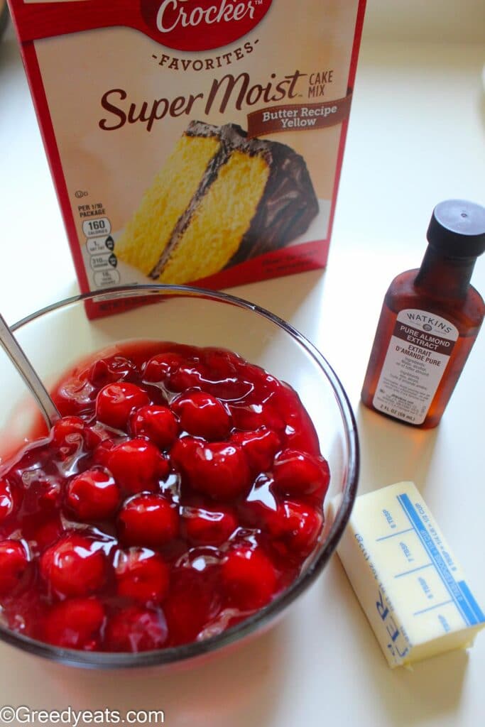 Ingredients like butter, cake mix and pie filling to make dump cake