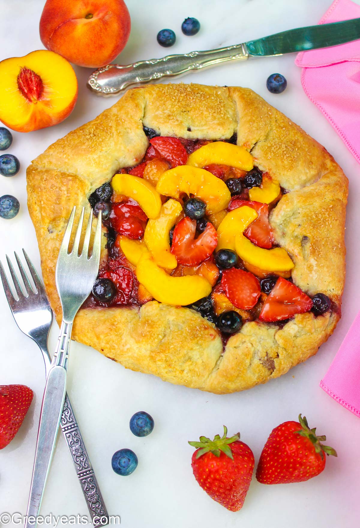 Homemade berry peach Galette is a perfect summer dessert with sweet fruit filling.