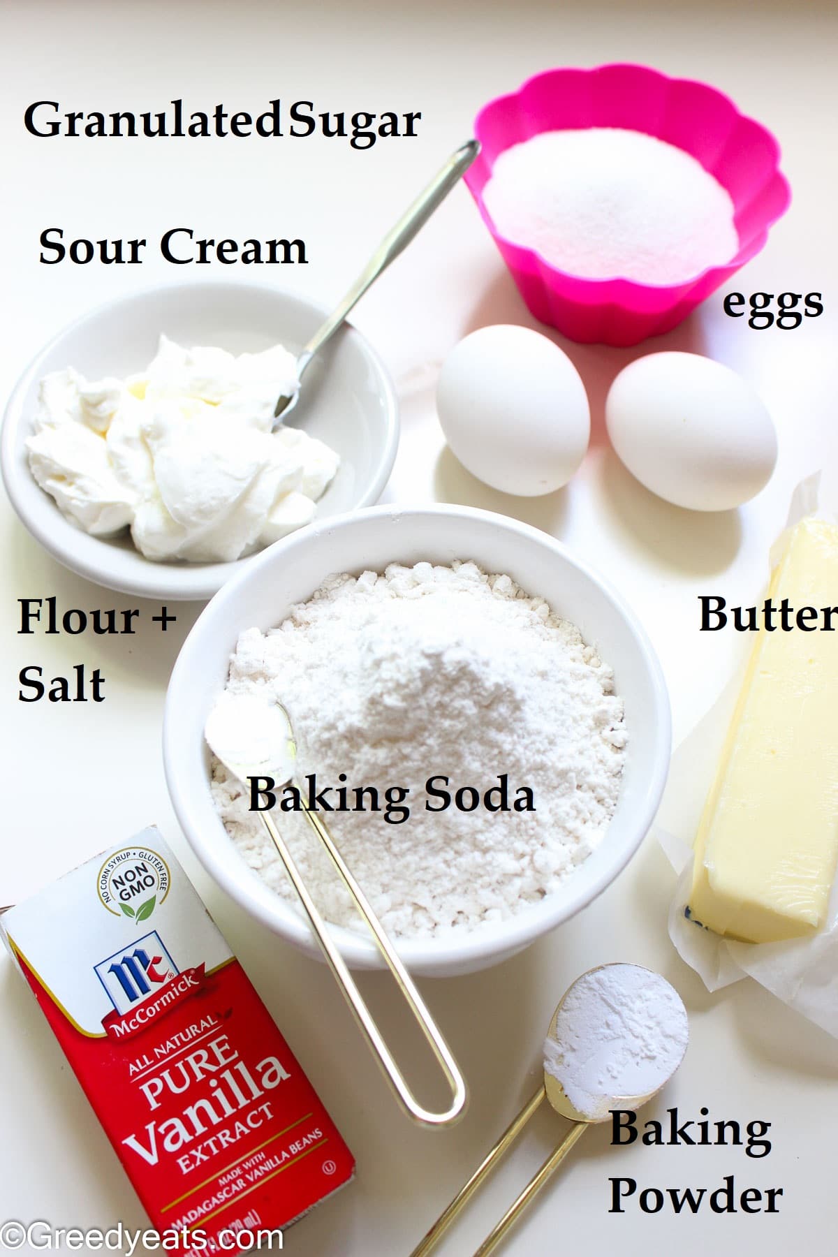 Ingredients like flour, eggs, vanilla, butter and sour cream to make coffee cake.