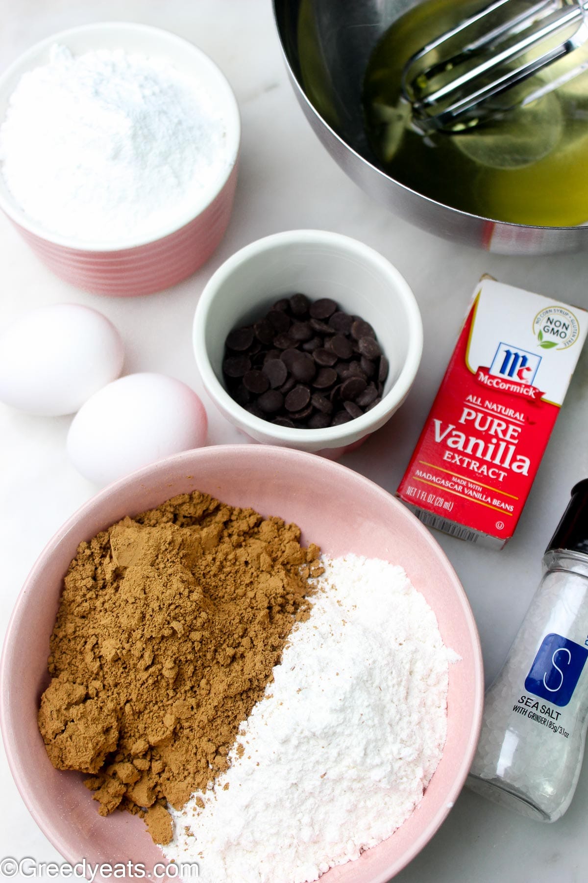Ingredients like cocoa, flour, eggs, vanilla and sugar to make brownies.