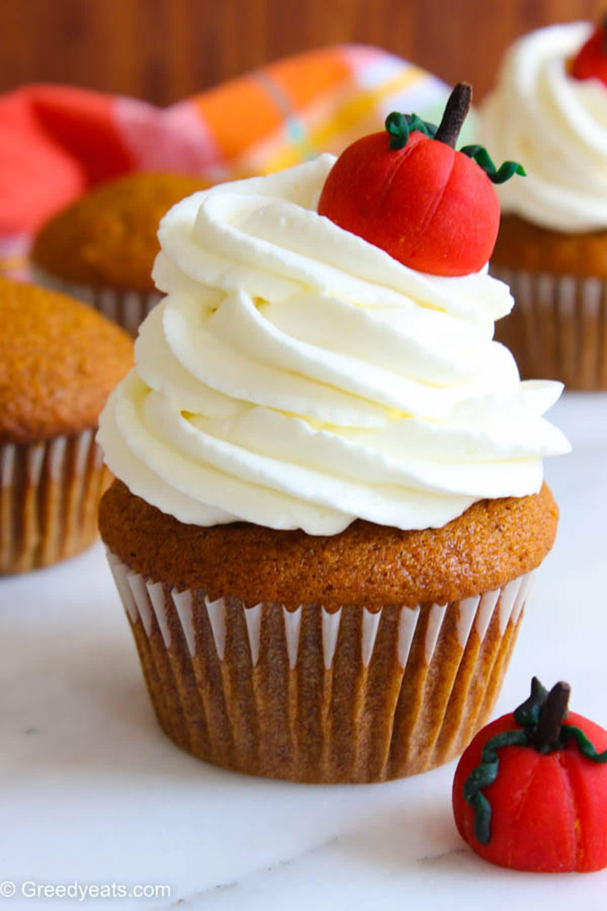 Pumpkin Cupcakes topped with creamy and dreamy cream cheese frosting swirls.