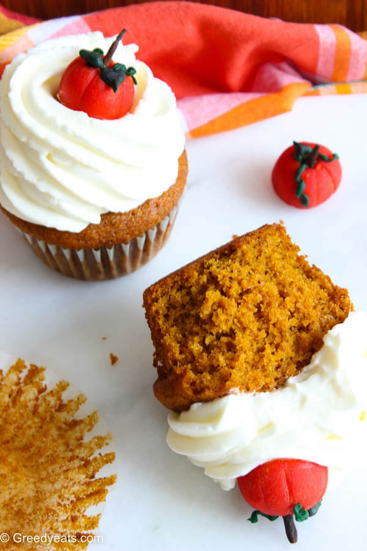 Best Pumpkin Cupcakes with light and creamy Pumpkin frosting and a cute fondant pumpkin topper.