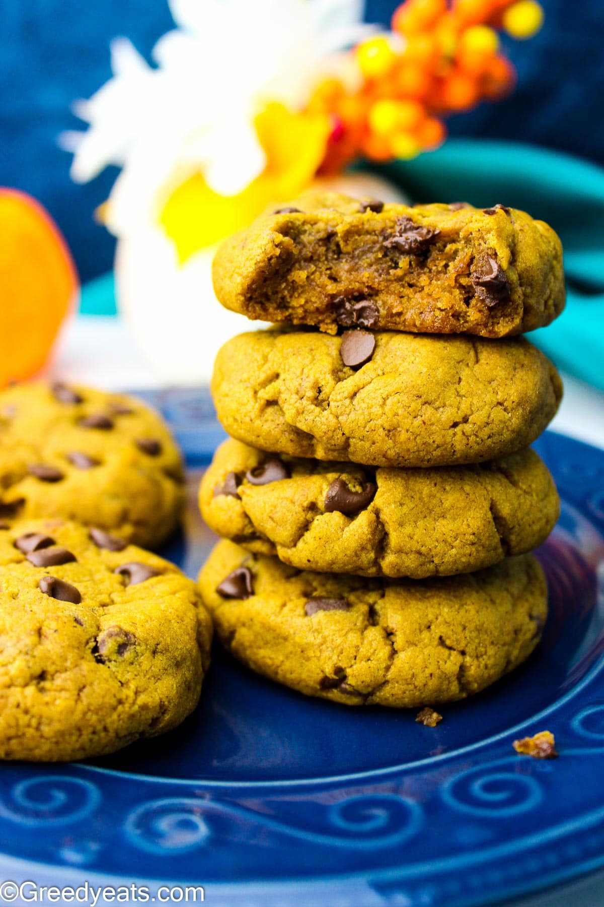 A stack of chewy and thick Pumpkin Cookies with fall spices and chocolate chips.