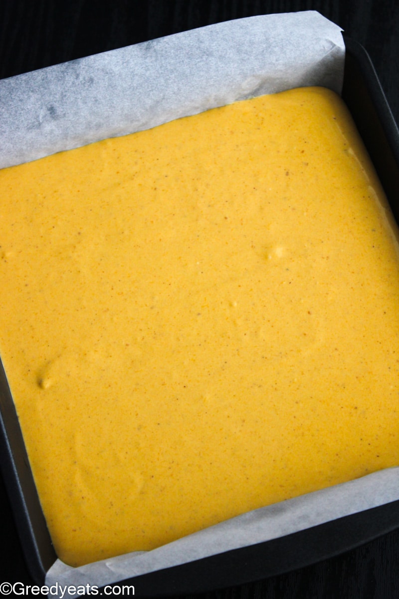 Pumpkin Pie batter in a square pan to be baked.