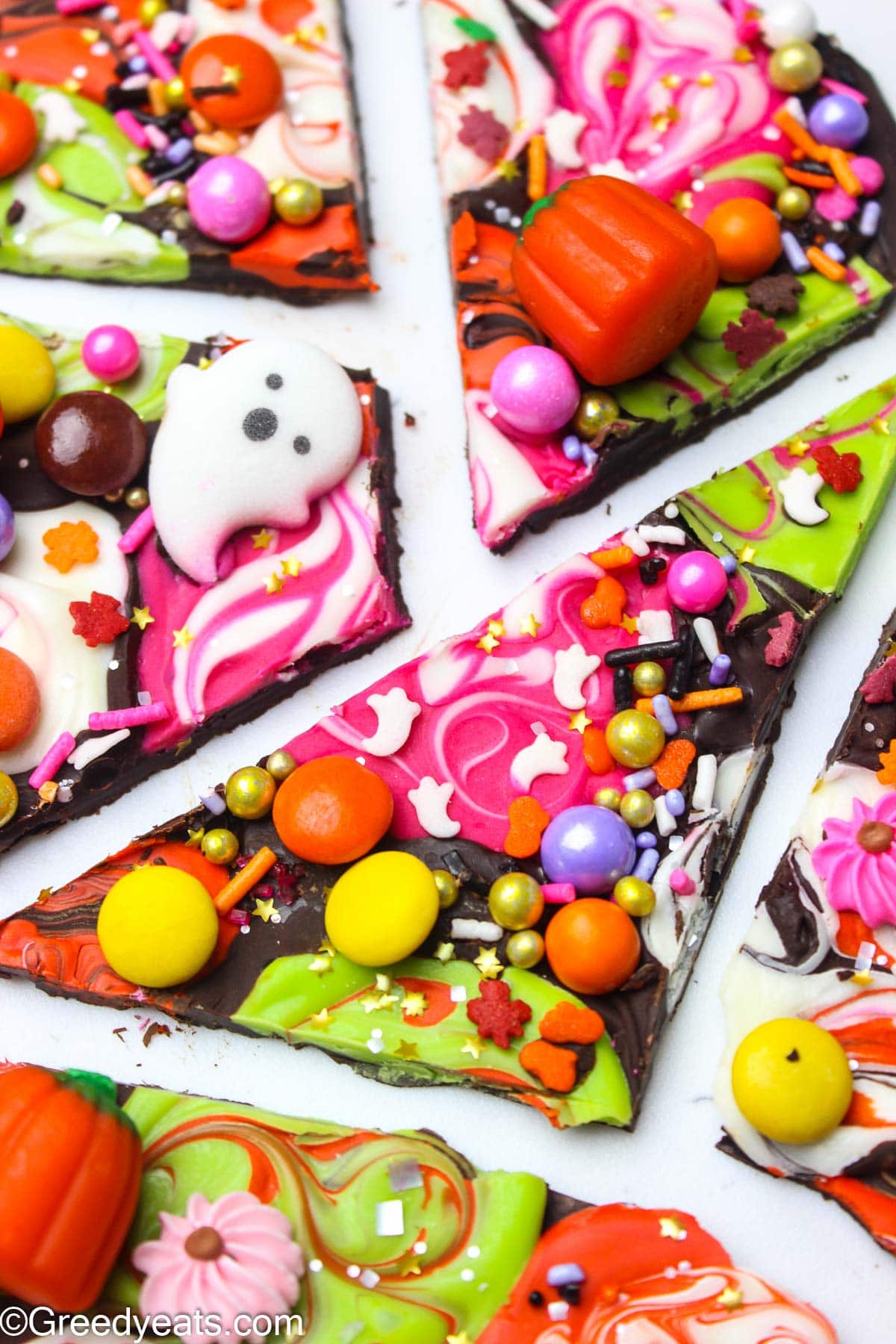 Bright and cutely spooky Halloween Candy Bark made with dark chocolate, sprinkles and m&ms.