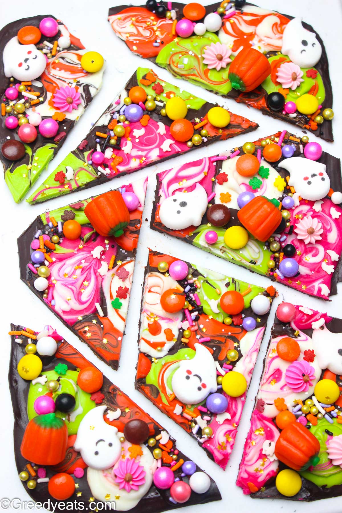 Chocolaty and decadent Halloween Bark topped with candy melts, sprinkles, pumpkins and m&ms.