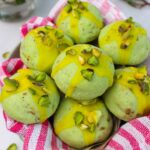 Soft, thick, buttery and crumbly Pistachio Shortbread Cookies with lemon glaze in a bowl.