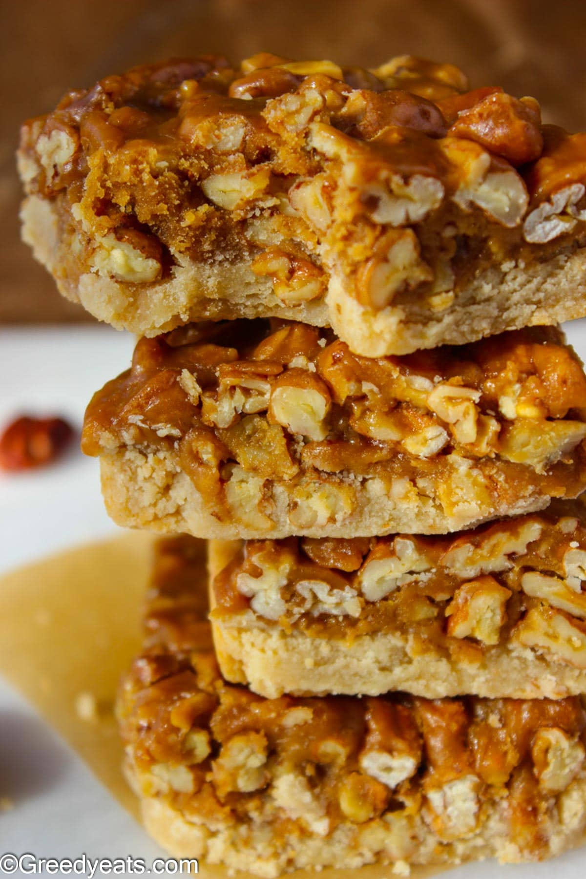 A stack of Pecan Bars with gooey pecan pie filling and butter shortbread crust.