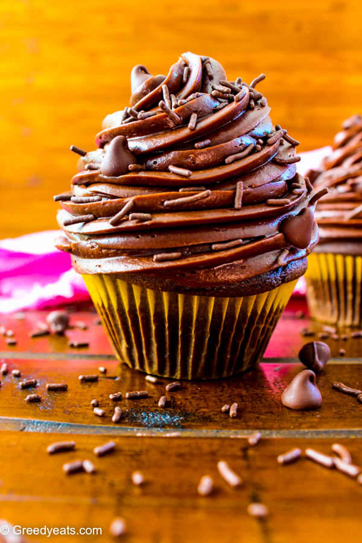 Unbelievably moist, light and decadent Chocolate Cupcakes with chocolate frosting and sprinkles.