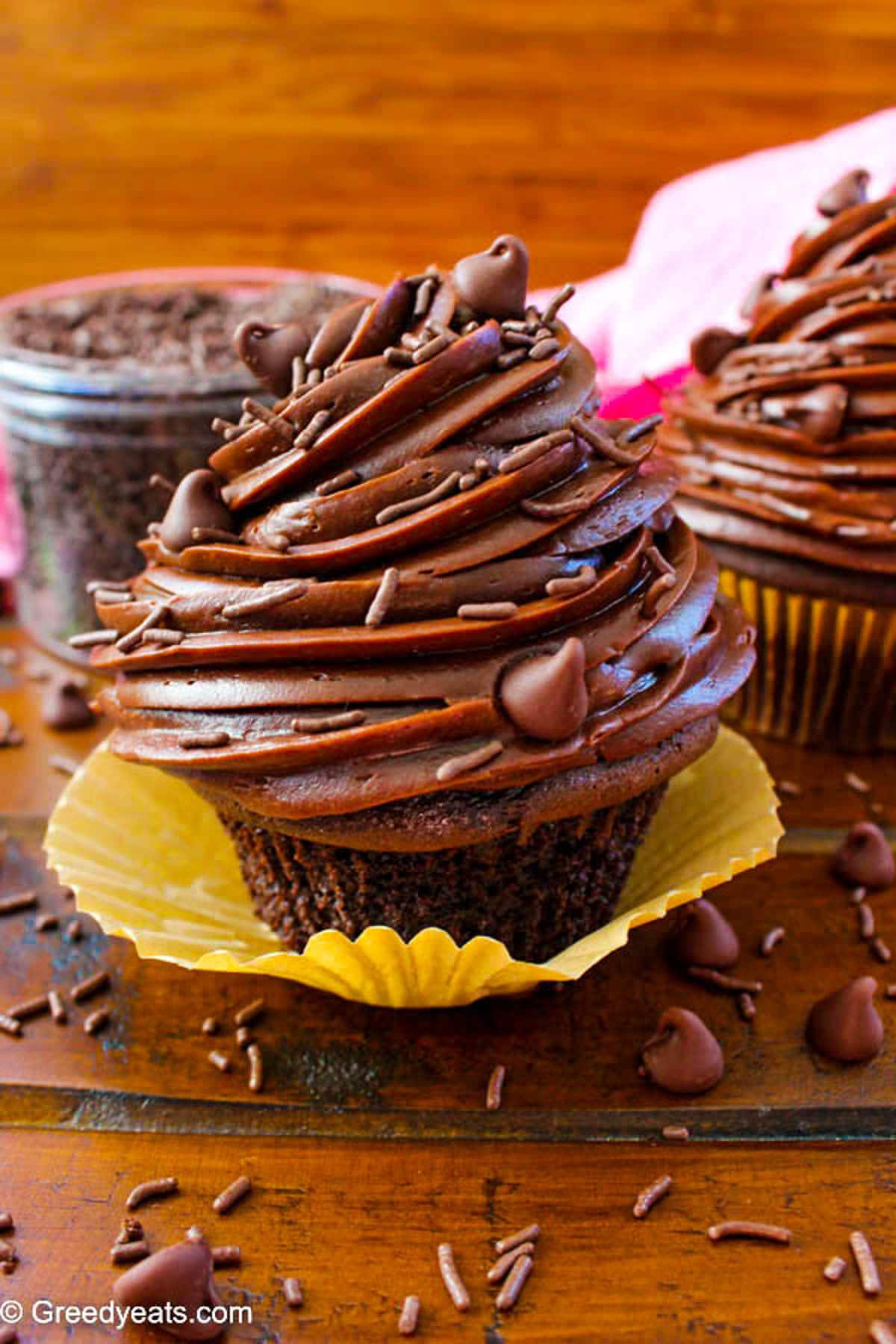 Supremely moist and decadent Chocolate Cupcakes topped with a huge pile of Creamy Chocolate Frosting.