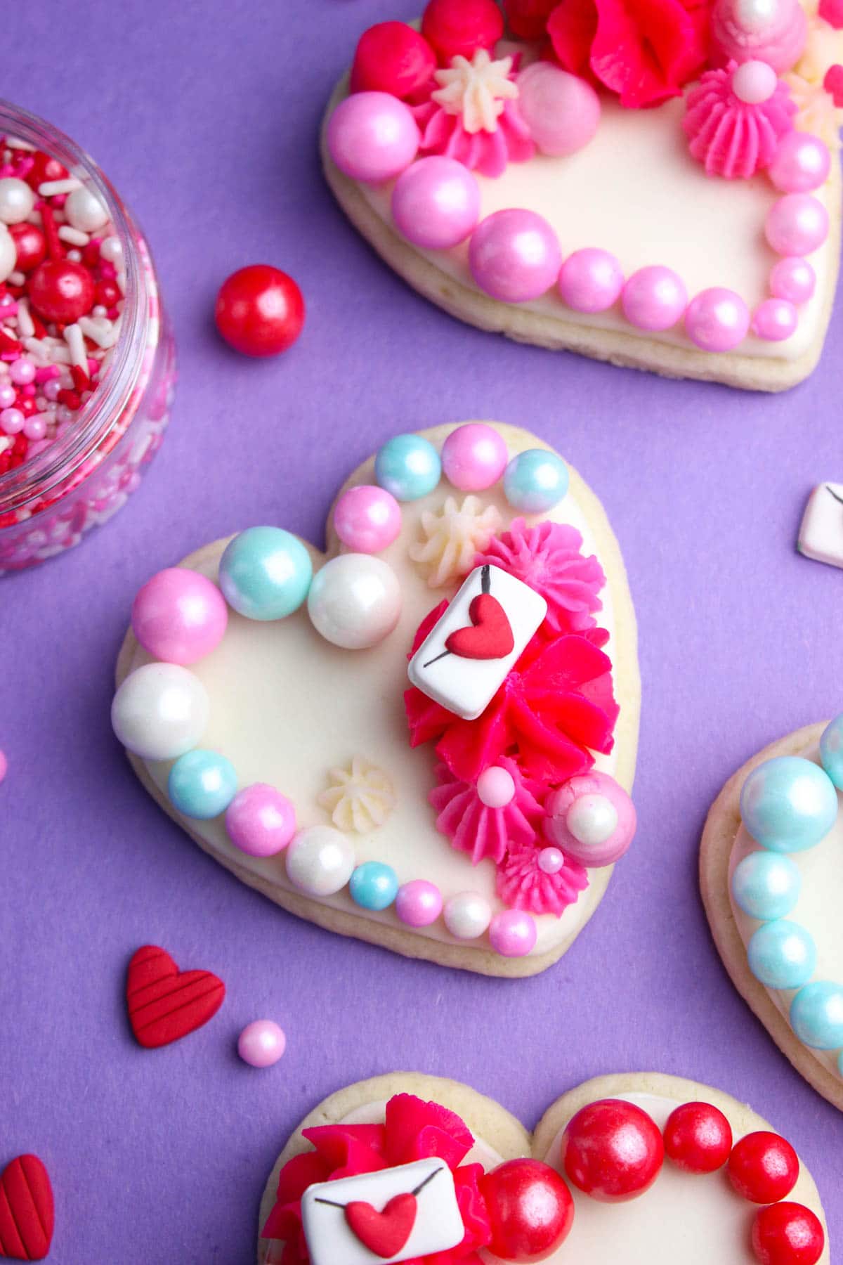 Heart Valentines Cookies with white royal icing, buttercream and love letters.