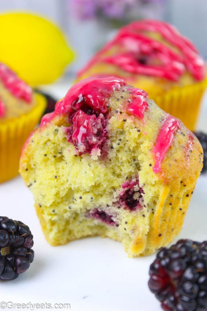 Soft and fluffy Lemon blackberry muffins with poppy seeds topped with berry glaze.