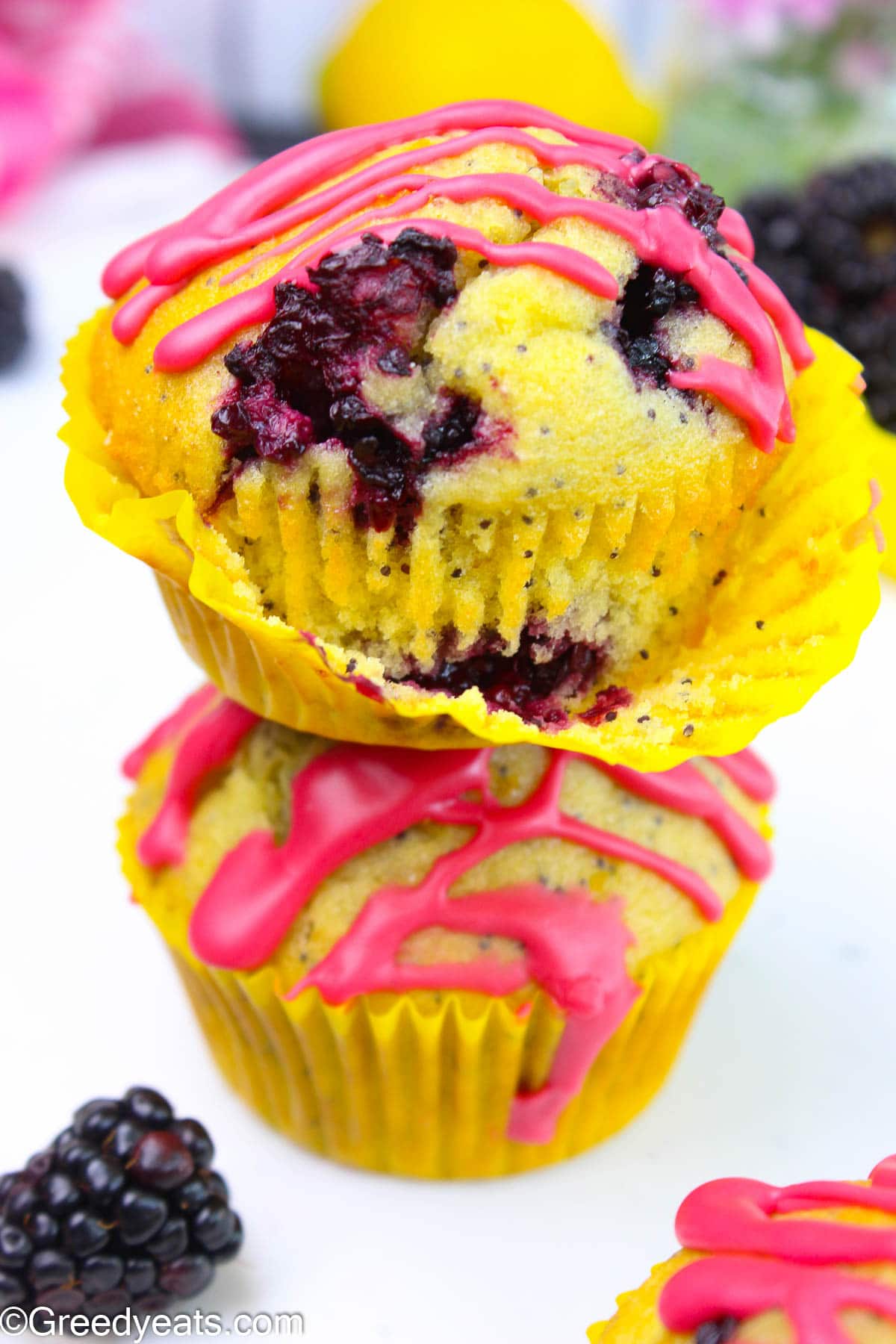 Blackberry Lemon Muffins flavored with fresh lemon, berry glaze and dotted with poppyseeds.