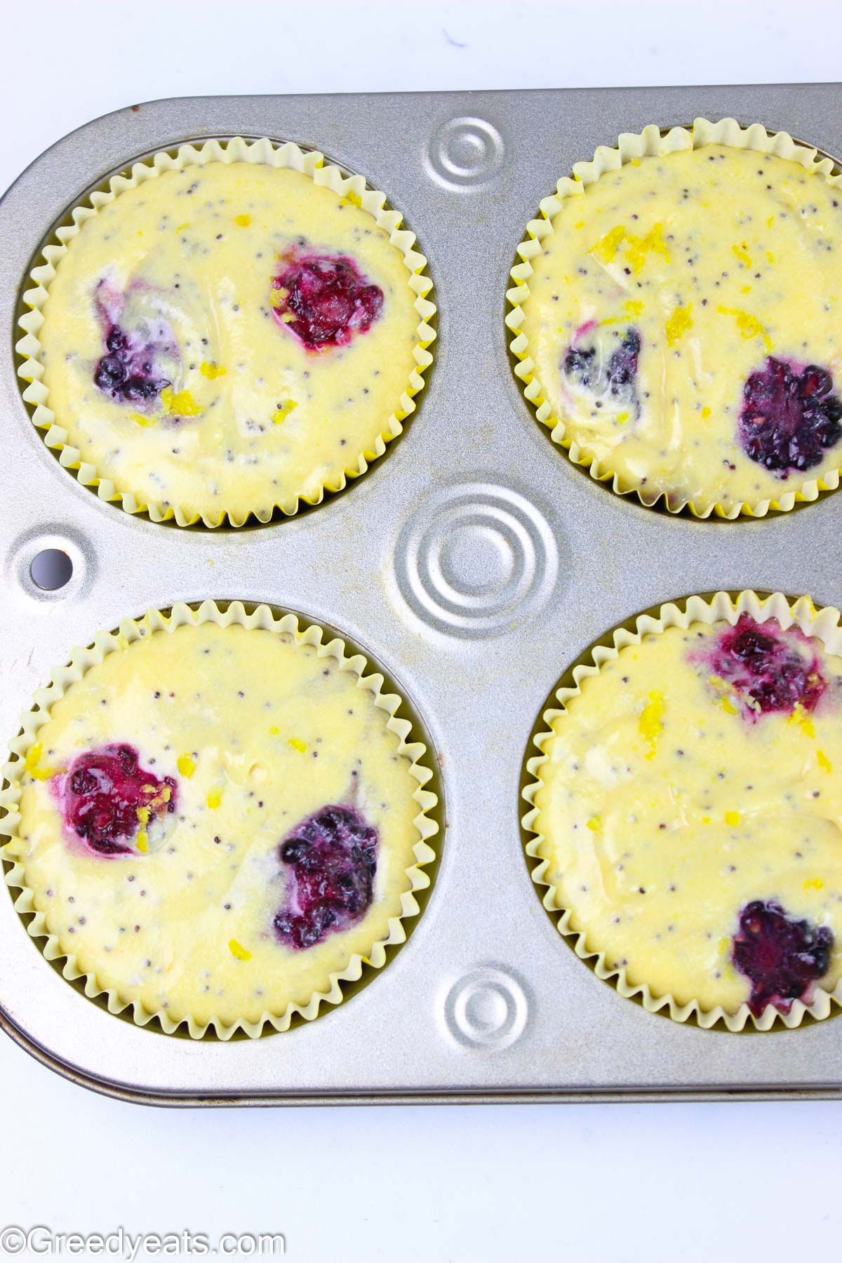 Lemon muffins batter poured in muffin tray ready to be baked.