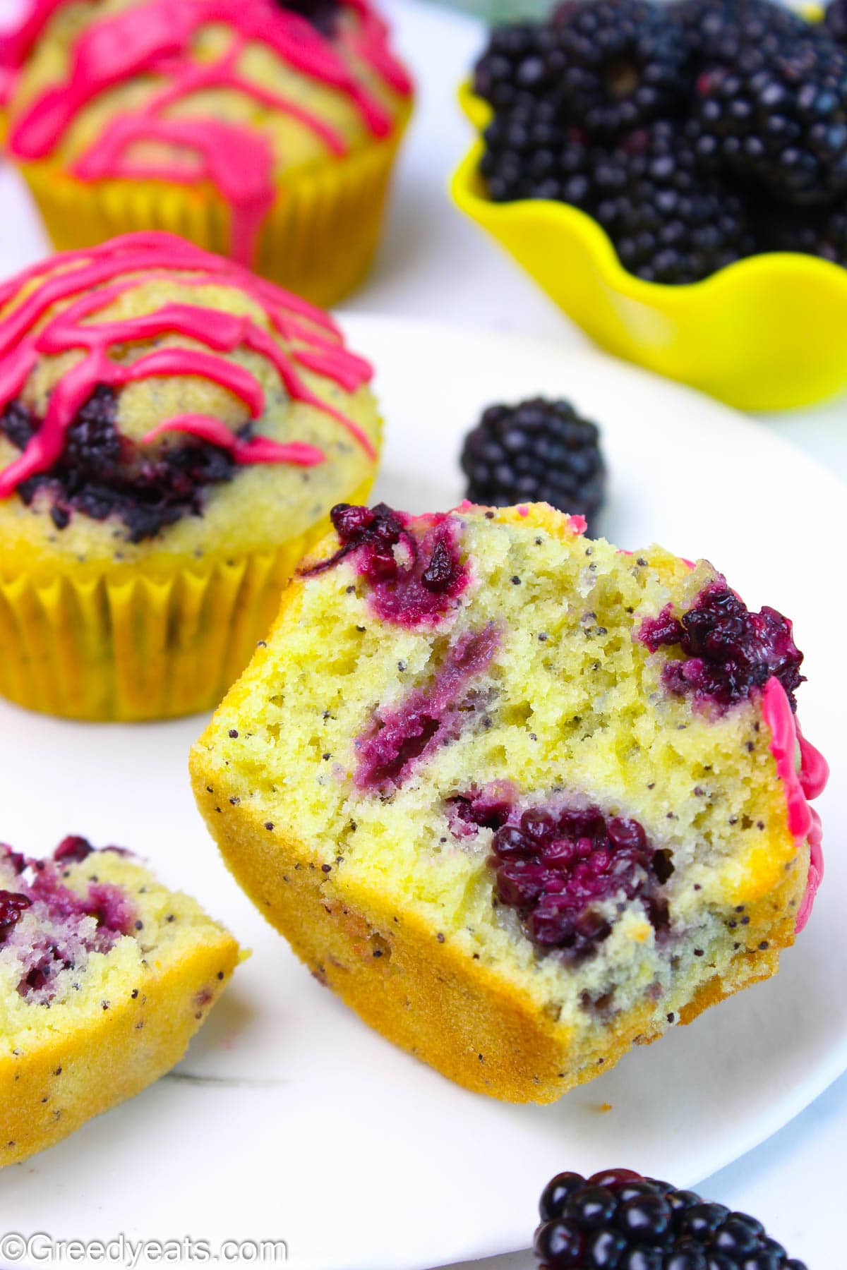 Soft, buttery, tall and moist Blackberry Lemon Muffins with sweet and tangy blackberry glaze.