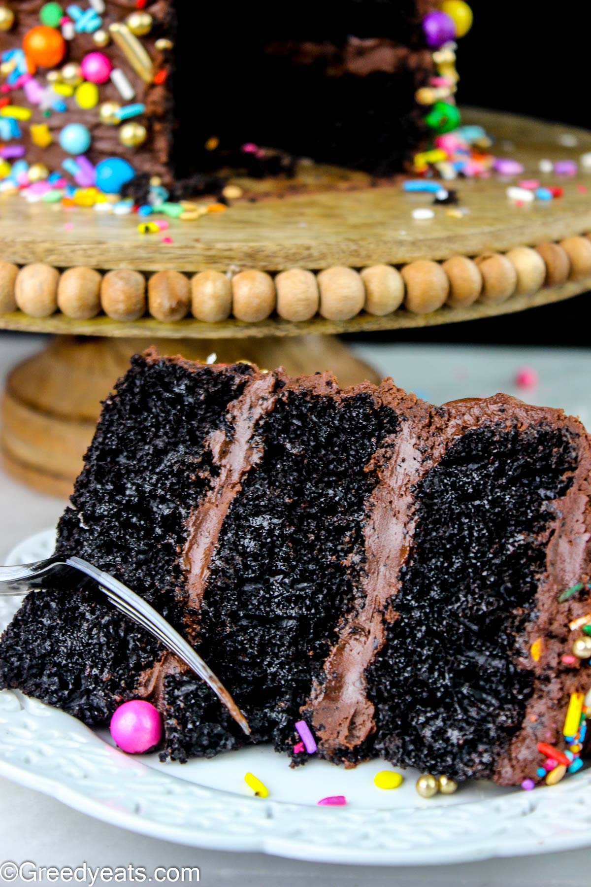 Soft, light yet decadent chocolate cake topped with rich chocolate buttercream and birthday sprinkles.