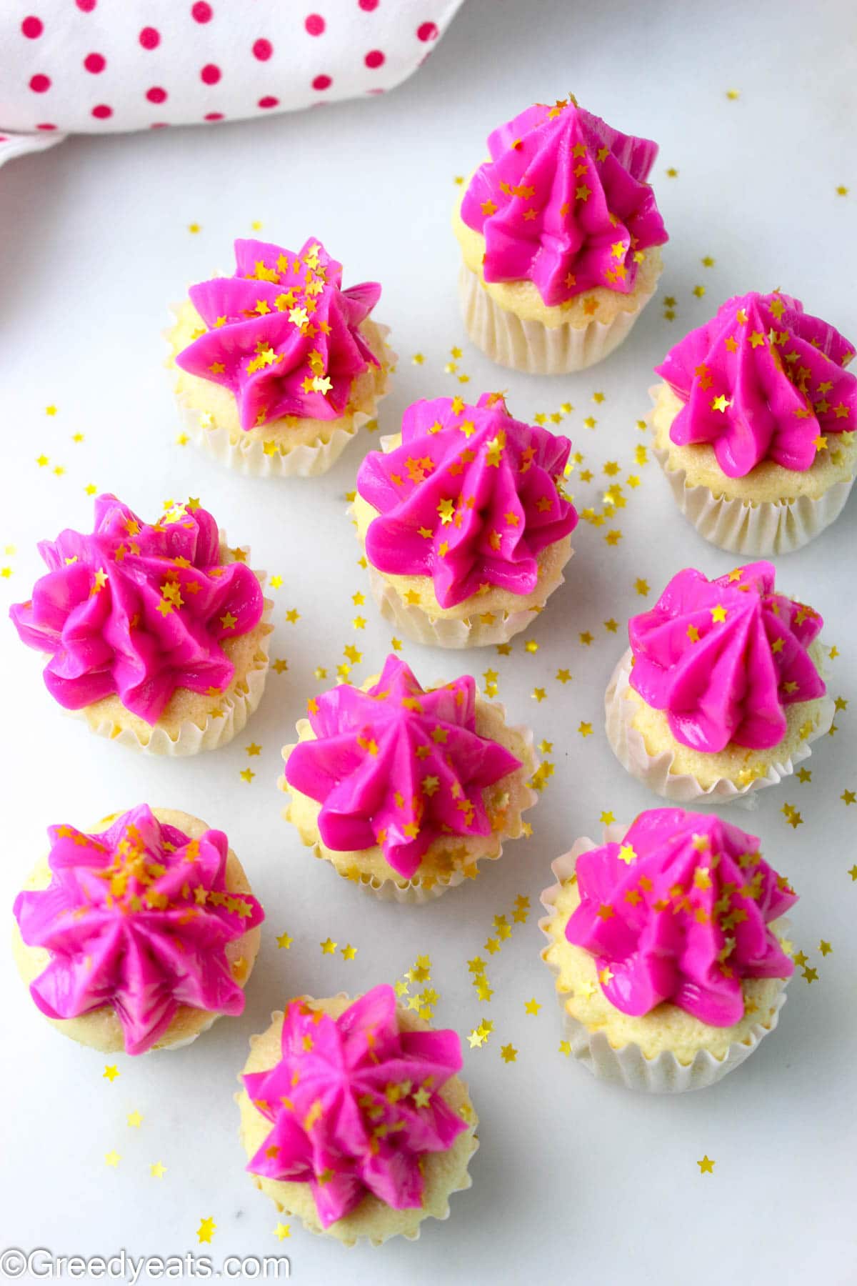 Soft and fluffy Mini Cupcakes topped with pink buttercream frosting and golden stars.