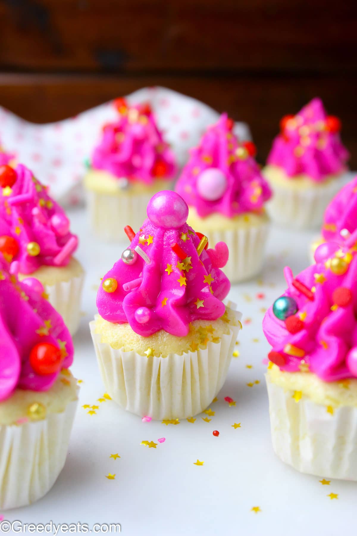 Quick and easy Mini Cupcakes topped with vanilla buttercream and sprinkles.