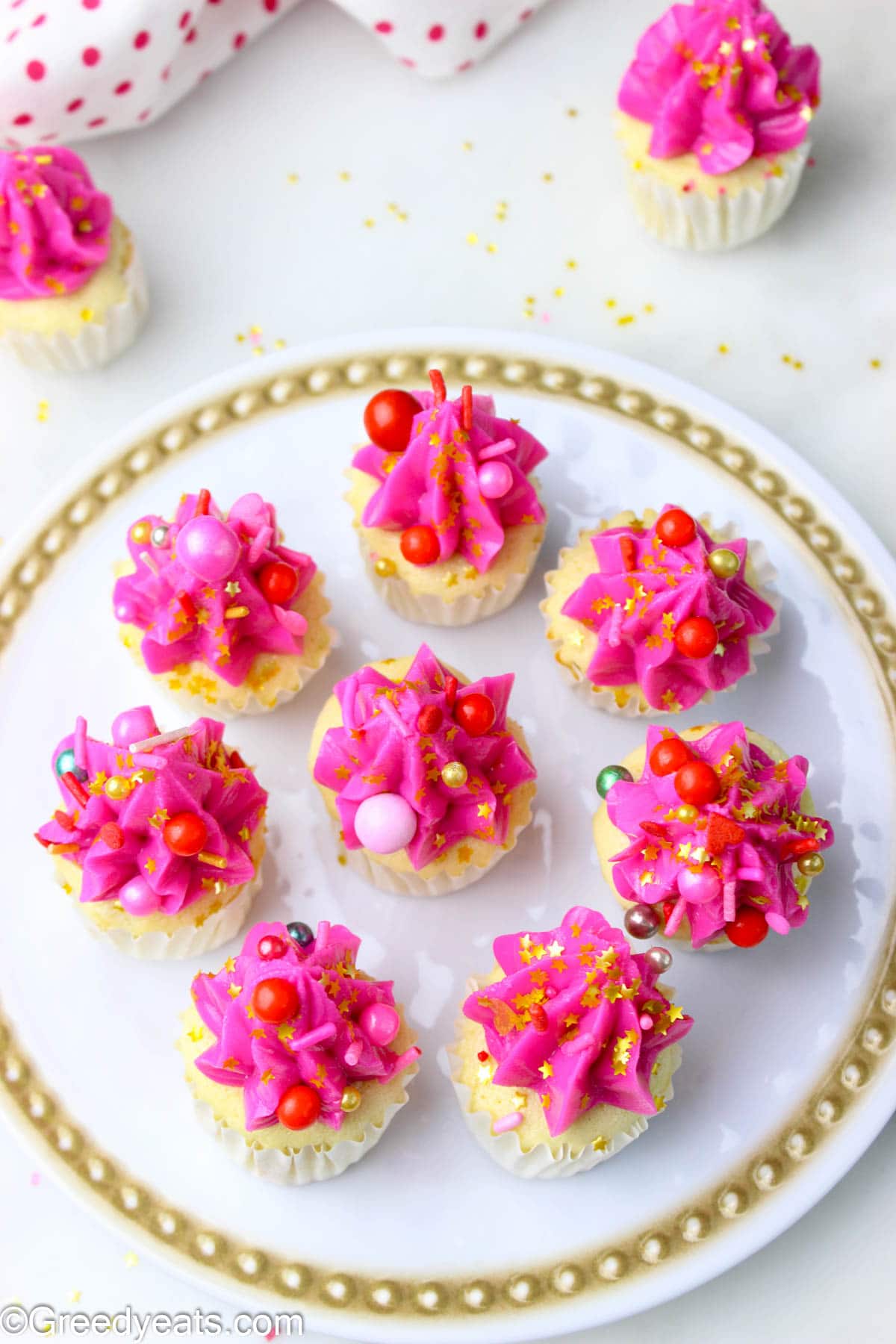 Mini Vanilla cakes frosted with buttercream and topped with sprinkles.