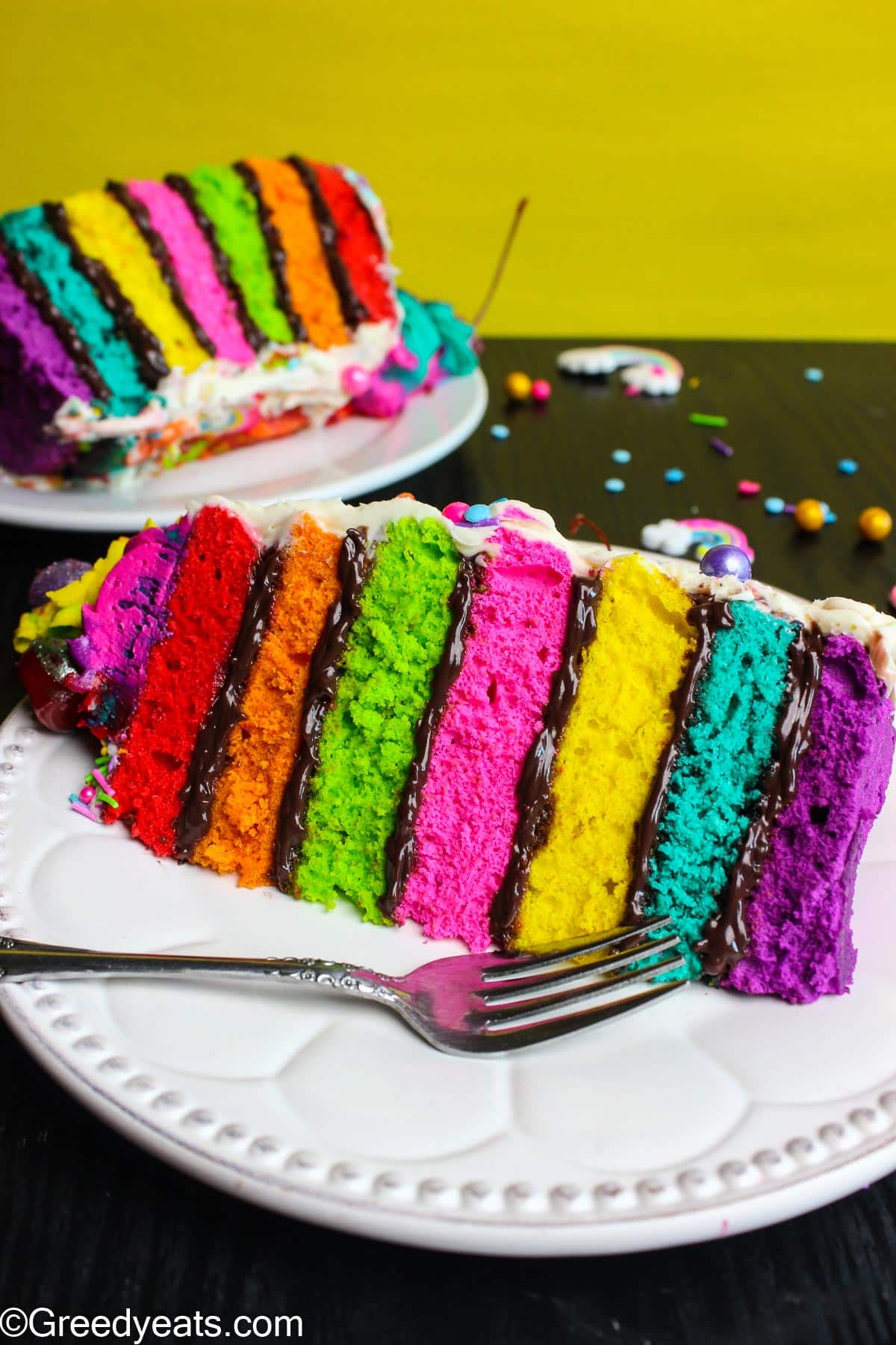 Moist and soft white velvet cake dressed up as Rainbow Cake layered with rich chocolate filling.