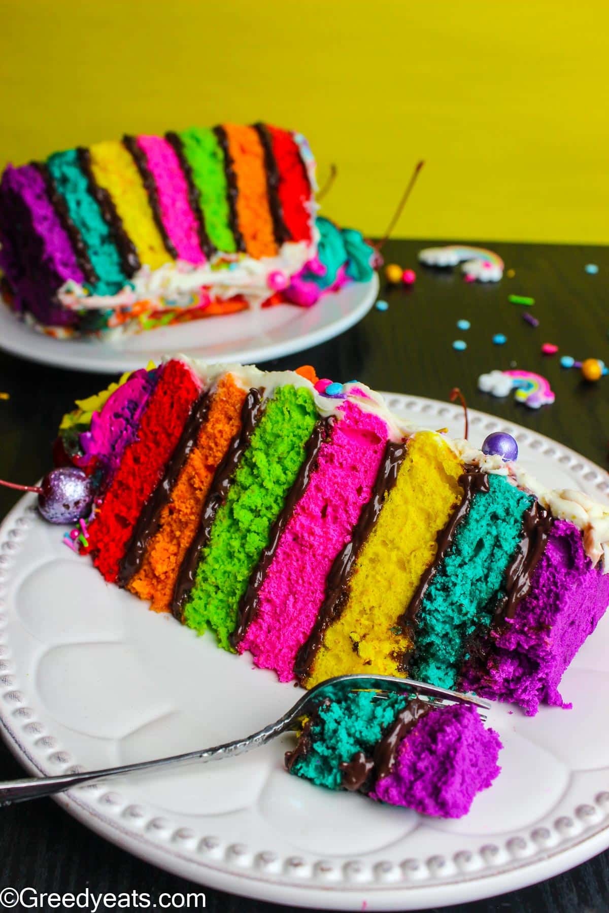 Soft, fluffy and moist Rainbow cake with chocolate filling, vanilla buttercream and rainbow swirls!
