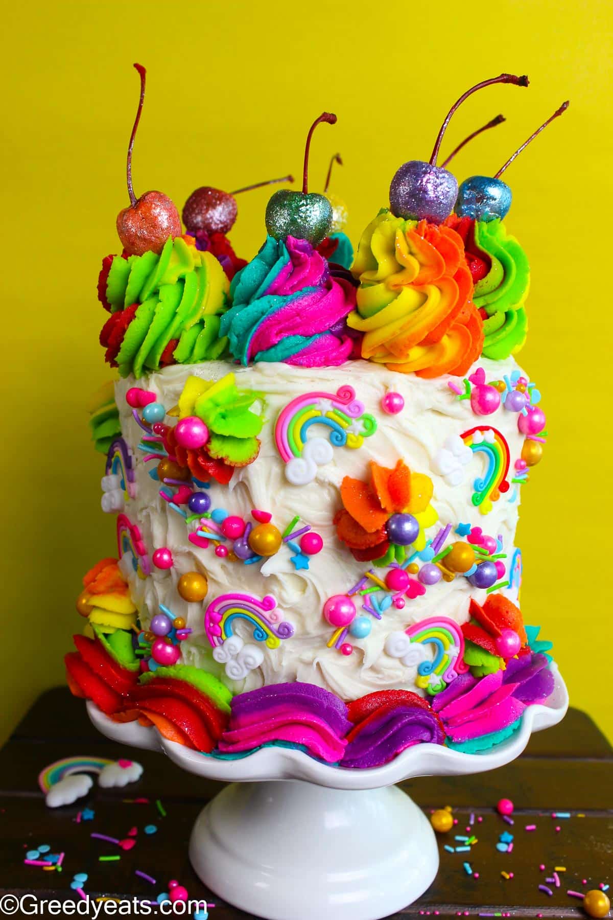 Rainbow Cake frosted with silky and smooth Vanilla buttercream and rainbow swirled buttercream.  