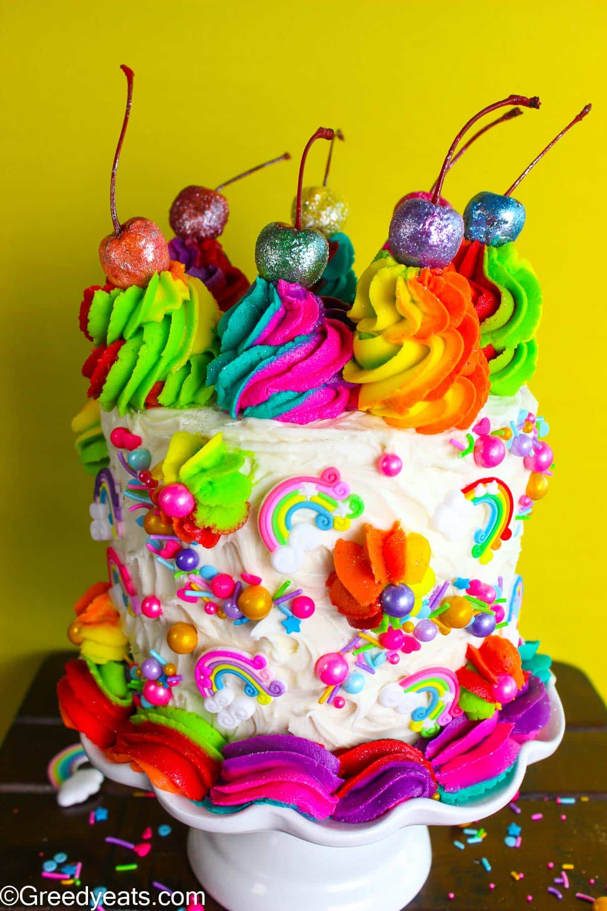 Soft and vibrant Rainbow Cake filled with rich chocolate filling and Vanilla Buttercream frosting.