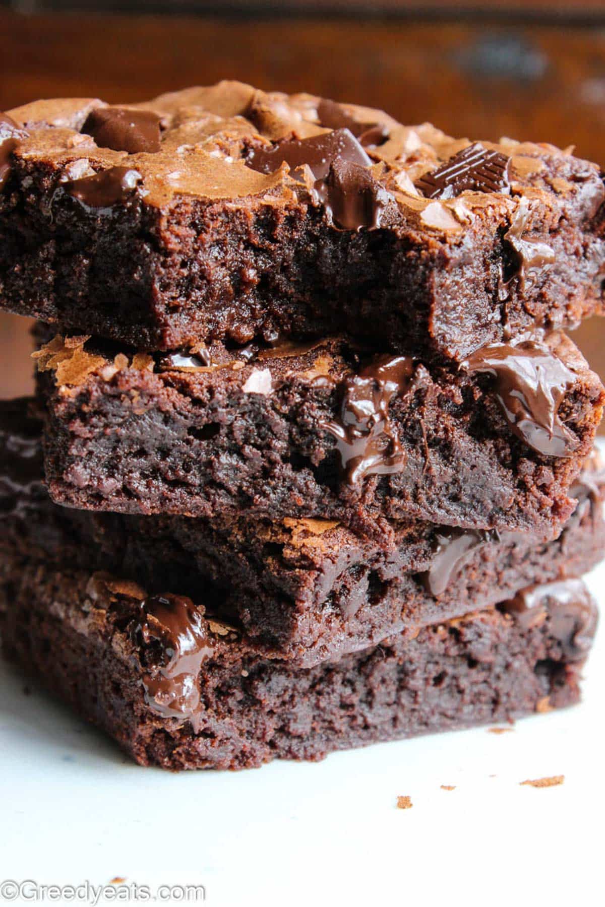 Stack of fudgy Brownies oozing with pockets of melty chocolate chunks.
