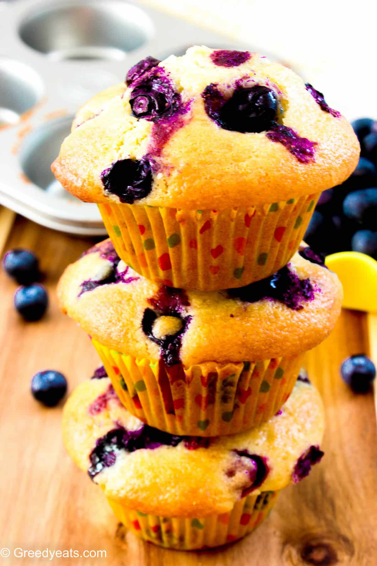 A stack of fresh Blueberry Lemon Muffins that bake tall, soft fluffy yet super moist.