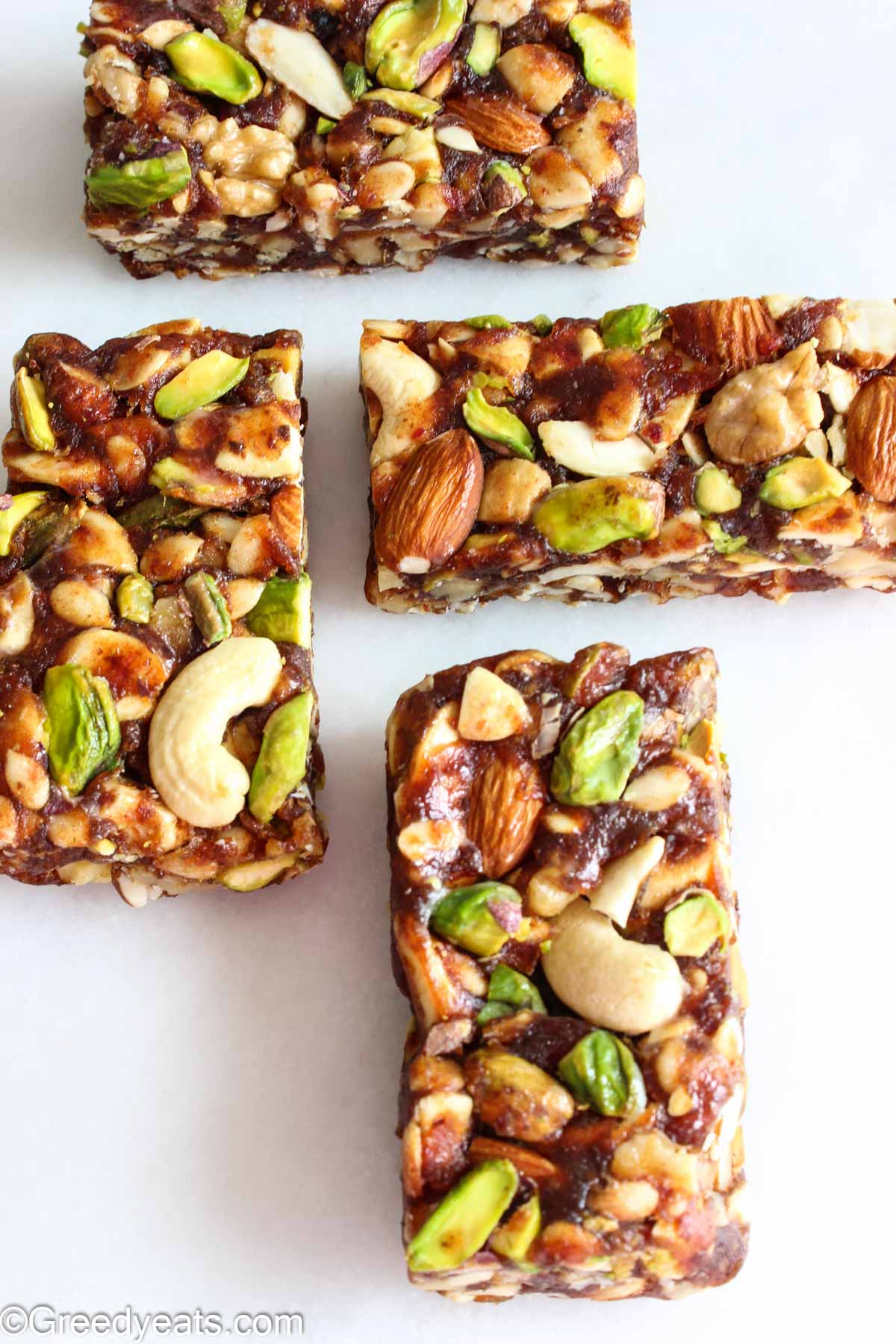 Date nut bars are Healthy Bars loaded with nuts and nutrients. Served as Breakfast Bars on a white board.