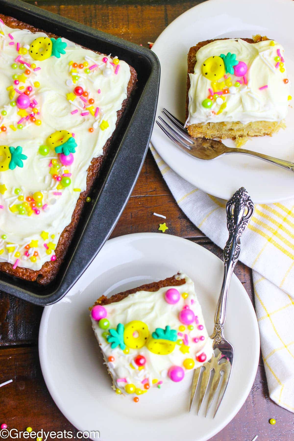 Crushed Pineapple cake with pineapple tid-bits all around, topped with easy frosting recipe and sprinkles.
