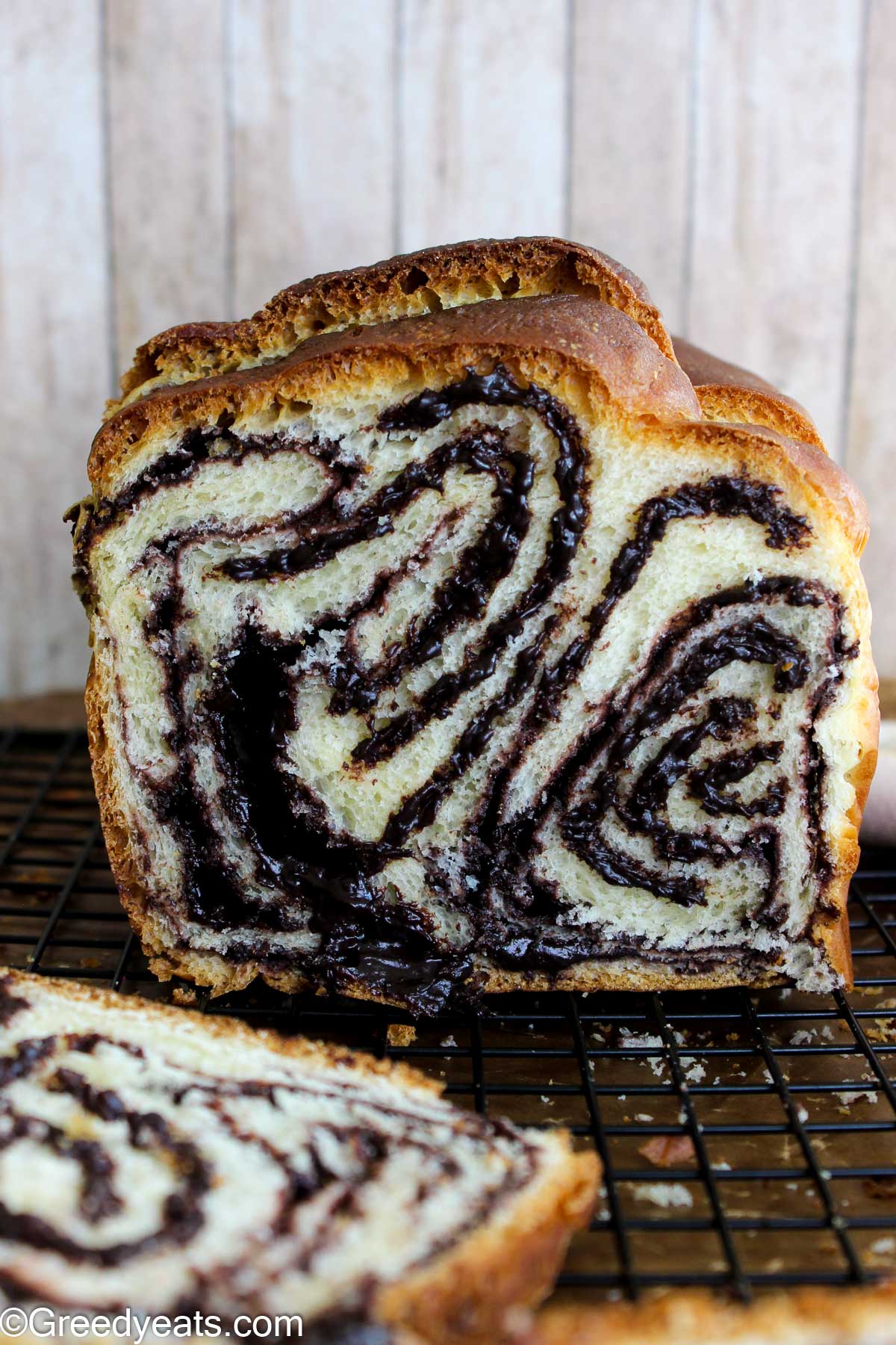 Soft and buttery Babka bread with decadent chocolate filling, cooling on a wire rack.