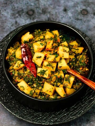 Spinach recipe made with potatoes and spinach - Aloo Palak recipe with garlic and onion.