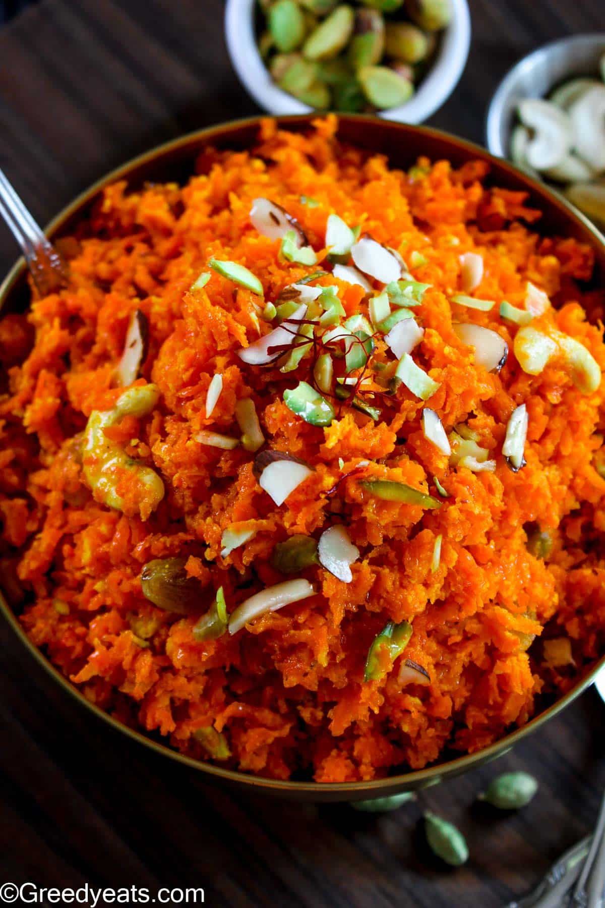 Quick Carrot Halwa made with condensed milk and khoya, served with nuts topping.
