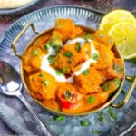 Panner tikka masala served with bell peppers, onions and lemon.
