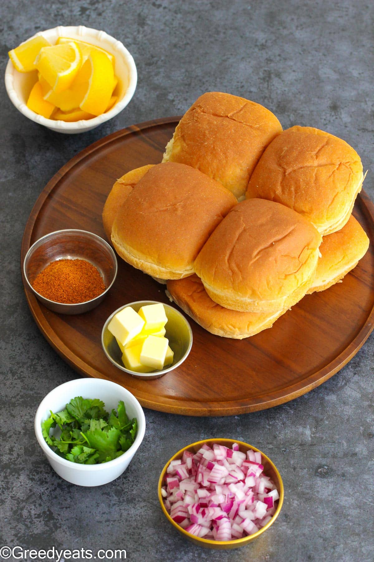 Ingredients like butter and pav bhaji masala to toast pav. Also lemon wedges and cilantro to serve bhaji.