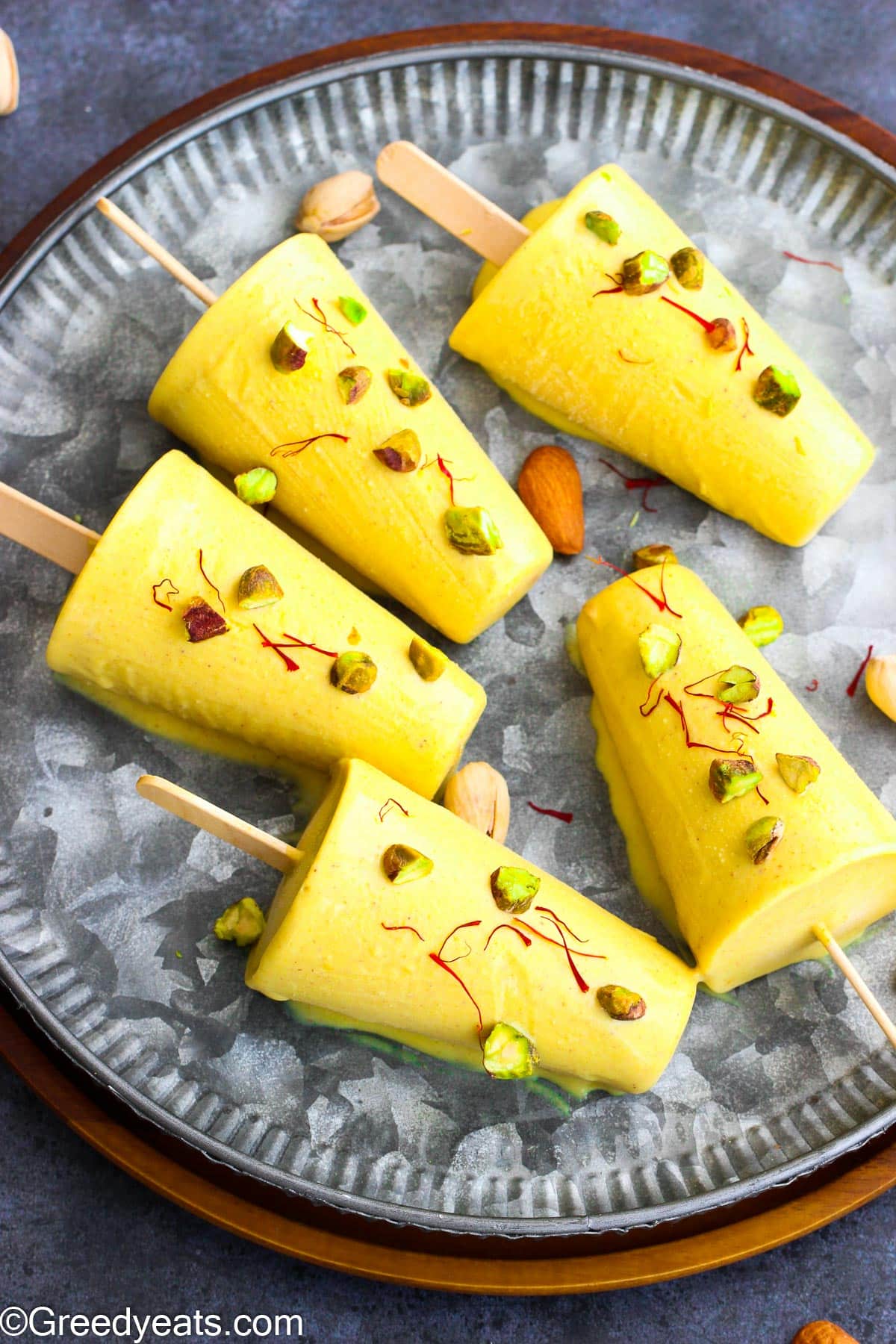 Easy Kulfi Recipe made with 3 kinds of milk, nuts, cardamom and saffron.