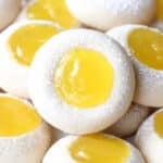 A stack of soft Lemon Curd Cookies filled with homemade Lemon Curd and dusted with powdered sugar.