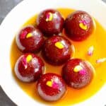 Homemade Gulab Jamuns made with milk powder and soaked in flavored sugar syrup.